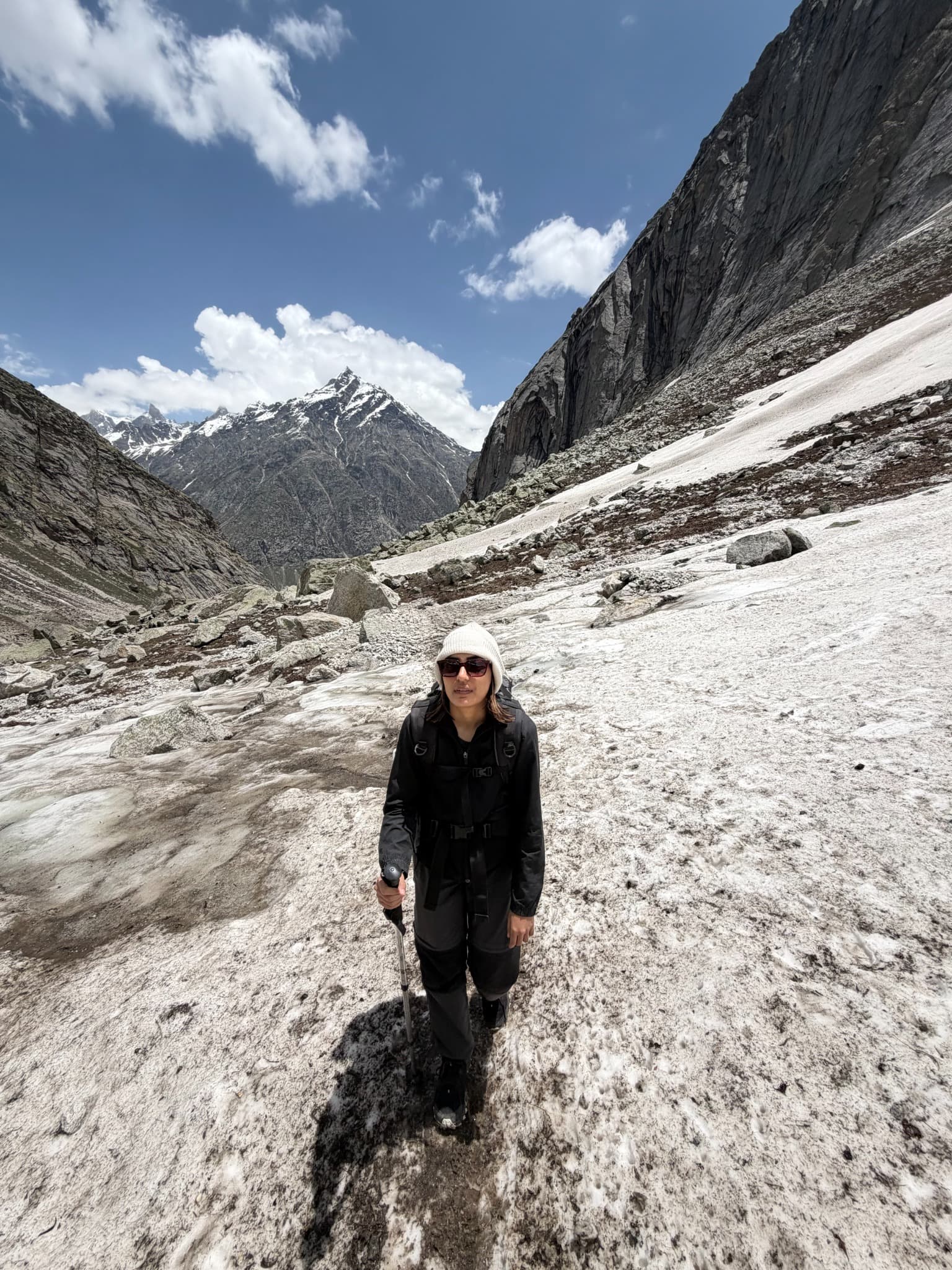 Sanskruti trekking across a snow-covered Himalayan mountain pass